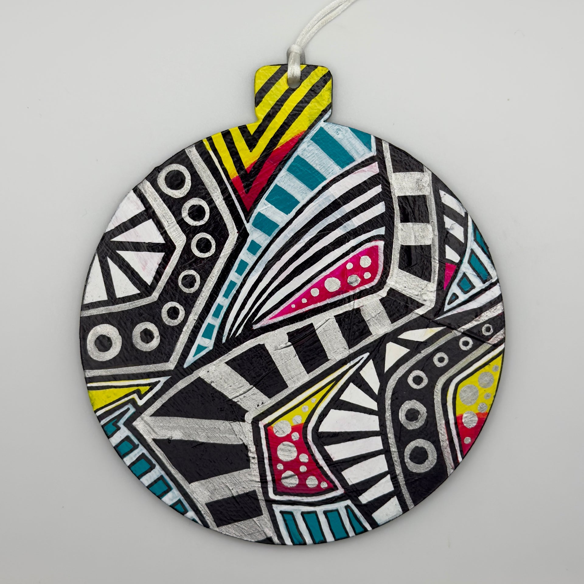 Hand-painted 4.25-inch ornament by Mary-Jo Lough featuring bold colors and intricate patterns, adding a unique touch to holiday decor.