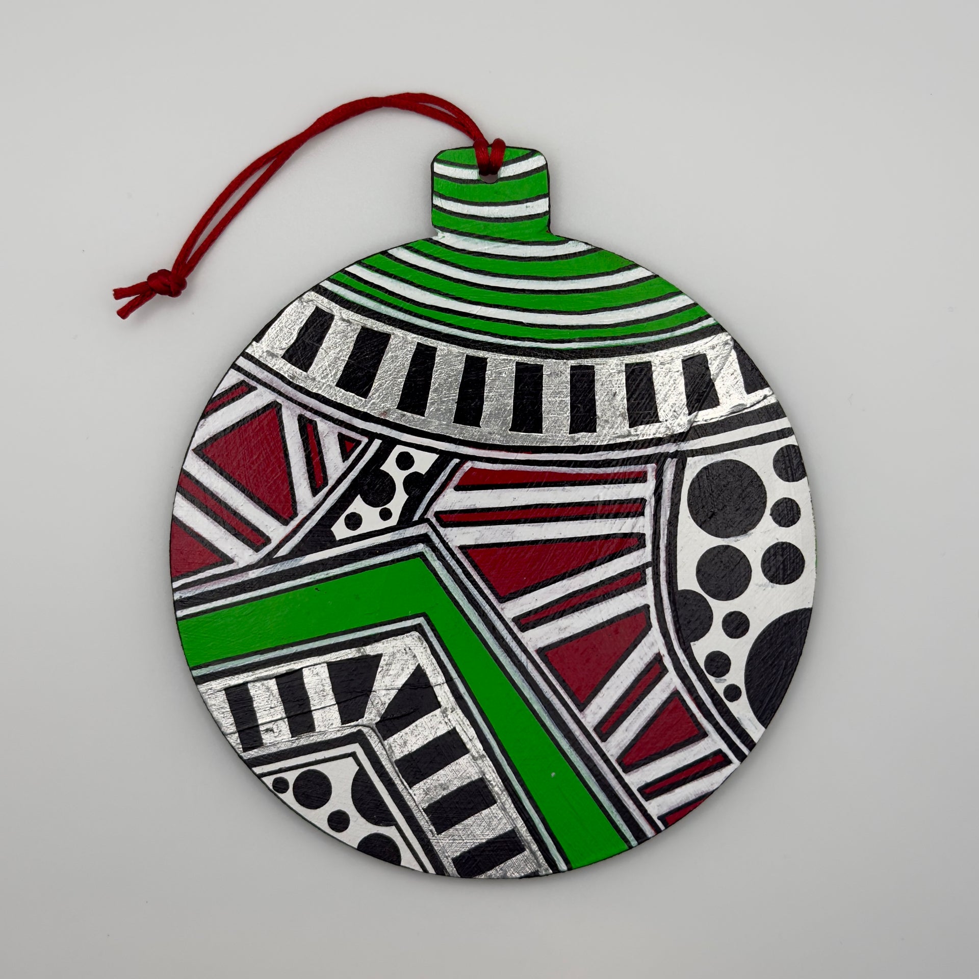 Hand-painted 4.25-inch ornament by Mary-Jo Lough featuring bold colors and intricate patterns, adding a unique touch to holiday decor.