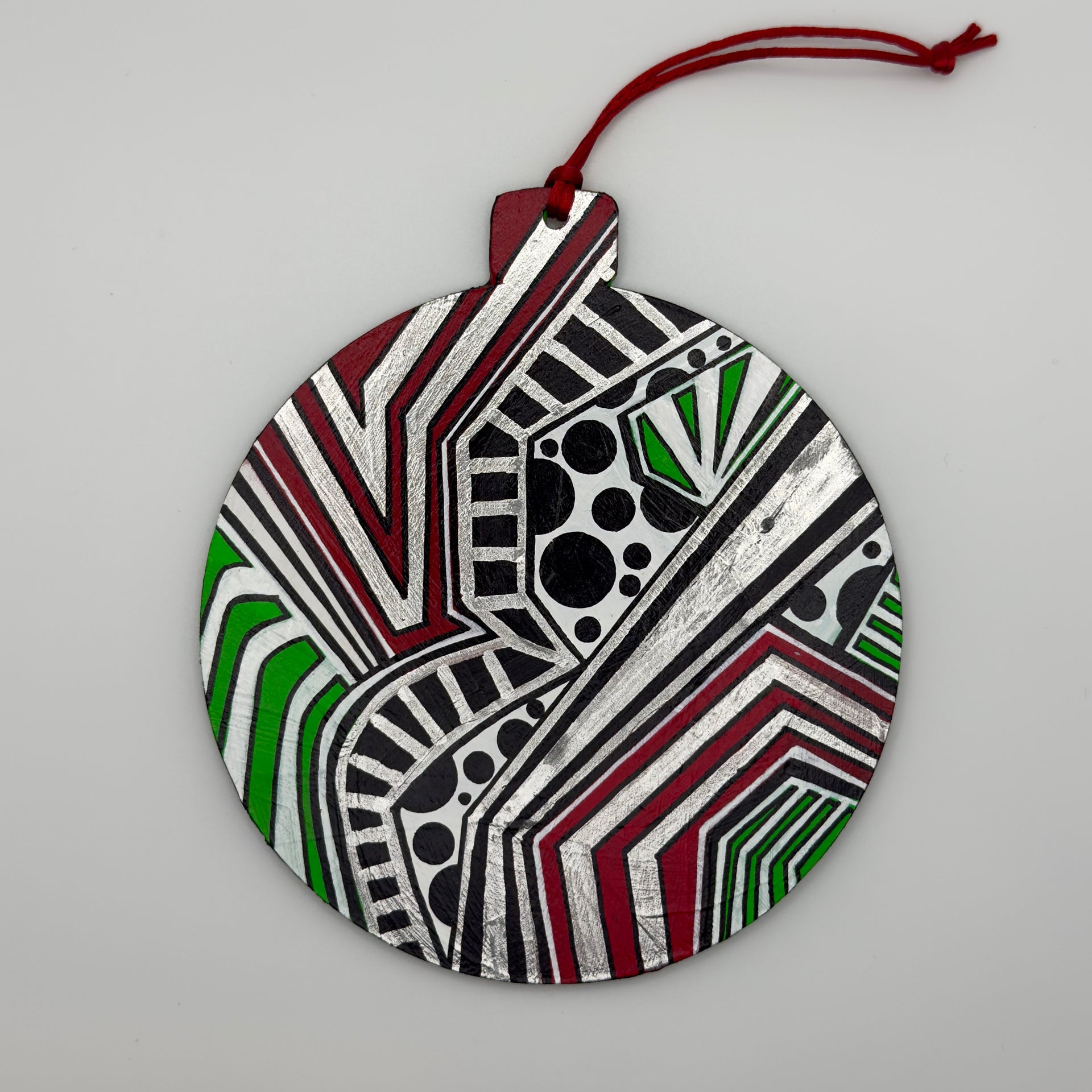 Hand-painted 4.25-inch ornament by Mary-Jo Lough featuring bold colors and intricate patterns, adding a unique touch to holiday decor.