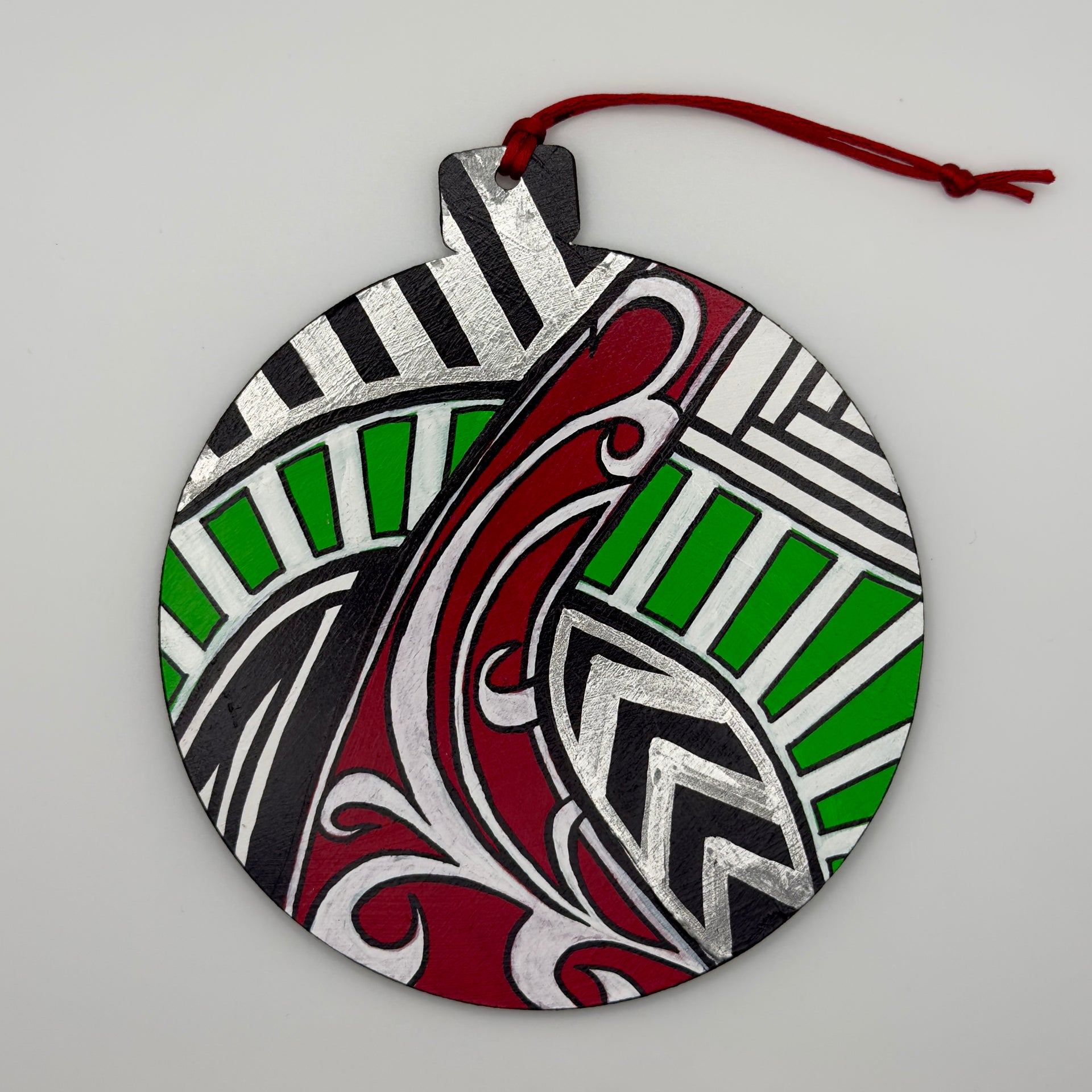 Hand-painted 4.25-inch ornament by Mary-Jo Lough featuring bold colors and intricate patterns, adding a unique touch to holiday decor.