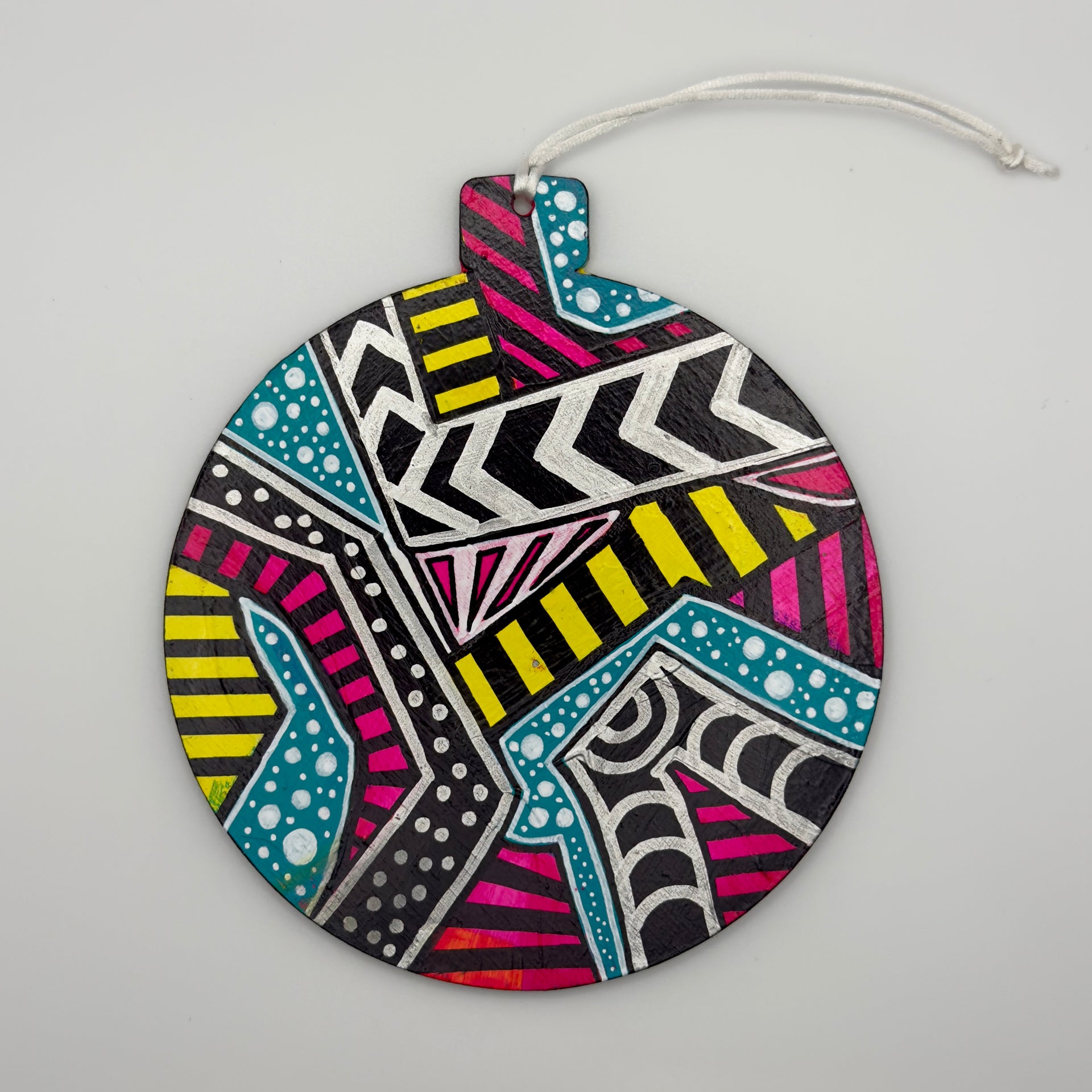 Hand-painted 4.25-inch ornament by Mary-Jo Lough featuring bold colors and intricate patterns, adding a unique touch to holiday decor.