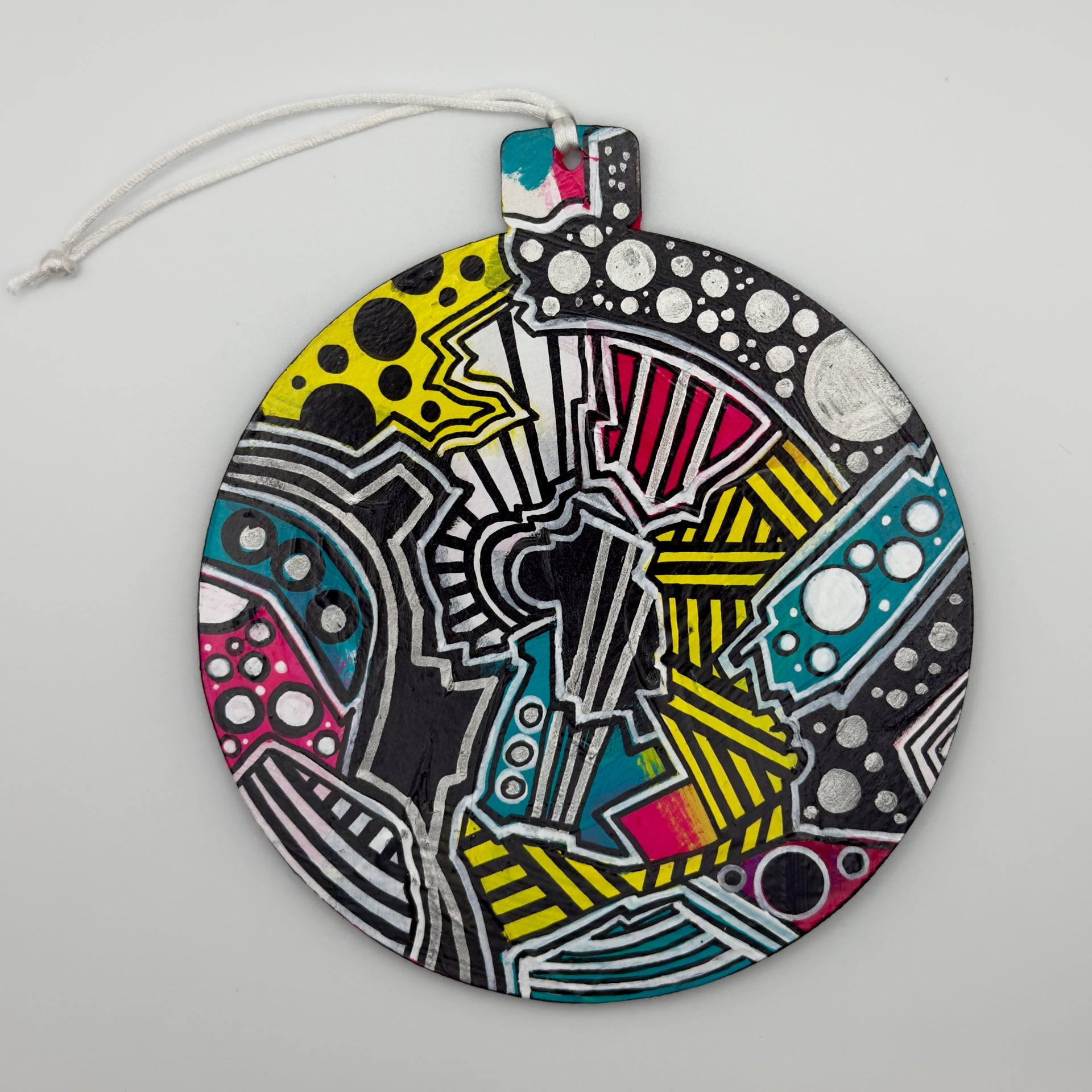 Hand-painted 4.25-inch ornament by Mary-Jo Lough featuring bold colors and intricate patterns, adding a unique touch to holiday decor.