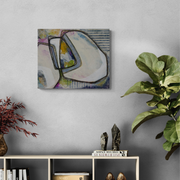 Abstract painting on a wall with decorative items below